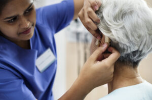senior lady being fitted for hearing aid