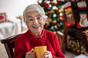 A senior woman appreciates being able to live at home while aging, one of the benefits of in-home care for older loved ones.